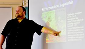 Travis Stimeling opens a series of sessions with a presentation on stereotypes about Appalachia. 