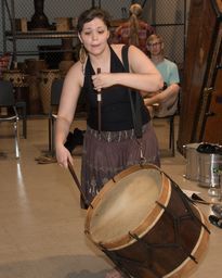 Woman playing a drum instrument 