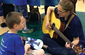 Music therapy student with child