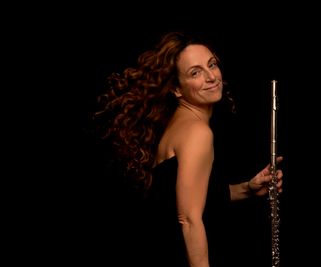 Nina Assimakopoulos headshot with a flute