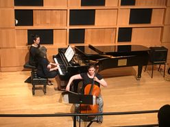 celloist and pianist play on stage